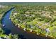 Aerial view highlights the waterfront community with houses and docks along a scenic river at 11109 Winn Rd, Riverview, FL 33569