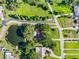 Landscaped lot featuring mature trees, adjacent to a pond and surrounded by neighborhood streets at 11109 Winn Rd, Riverview, FL 33569