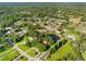 Property nestled on a large lot with a pond, surrounded by mature trees and green lawns at 11109 Winn Rd, Riverview, FL 33569