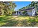 Expansive backyard featuring a well-maintained lawn and mature trees and landscaping at 11109 Winn Rd, Riverview, FL 33569