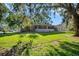 A generous yard featuring mature trees, lush green grass and room to roam at 11109 Winn Rd, Riverview, FL 33569