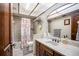 Bathroom with a shower-tub, vanity with sink, and updated lighting fixtures at 11109 Winn Rd, Riverview, FL 33569