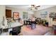 Bright bonus room features a ceiling fan, two windows, and a large crafting area at 11109 Winn Rd, Riverview, FL 33569