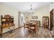Dining room featuring hardwood floors, stylish chandelier, and large window at 11109 Winn Rd, Riverview, FL 33569