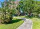 Charming single Gathering home with beautiful trees, a curved drive and a cheerful blue door at 11109 Winn Rd, Riverview, FL 33569