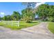 Charming house with a well-maintained lawn, mature trees, and a white picket fence at 11109 Winn Rd, Riverview, FL 33569