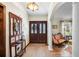 Inviting foyer with hardwood floors, coat rack, and a glimpse into the living room at 11109 Winn Rd, Riverview, FL 33569