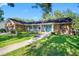 Charming single story home featuring stone accents, a cozy front porch, and well-manicured lawn at 11109 Winn Rd, Riverview, FL 33569