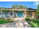 Inviting porch with blue double doors, stone accents, and landscaped garden at 11109 Winn Rd, Riverview, FL 33569