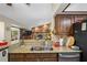 Open kitchen features granite countertops, stainless steel appliances, and a view of the living room at 11109 Winn Rd, Riverview, FL 33569