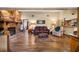 Comfortable living room with stone fireplace, wood floors, and ample seating at 11109 Winn Rd, Riverview, FL 33569