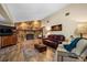 Living room featuring a stone fireplace and wood floors at 11109 Winn Rd, Riverview, FL 33569