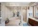 Bright main bathroom with step up soaking tub, a glass shower, dual sinks, and marble counter tops at 11109 Winn Rd, Riverview, FL 33569