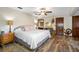 Spacious main bedroom with a ceiling fan, hardwood floors and a view to the en suite bathroom at 11109 Winn Rd, Riverview, FL 33569