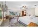 Large main bedroom with hardwood floors, ceiling fan, and sitting area with backyard view at 11109 Winn Rd, Riverview, FL 33569