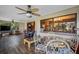 Bright sun room with hardwood floors, large windows, and comfortable seating at 11109 Winn Rd, Riverview, FL 33569