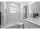 Modern bathroom with white marble, glass shower, and white vanity at 112 W Sligh Ave, Tampa, FL 33604