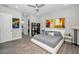 Spacious bedroom with king bed, wood floors, ceiling fan, and ensuite bathroom access at 112 W Sligh Ave, Tampa, FL 33604