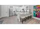 Bright kitchen with stainless steel appliances, granite countertops, and a breakfast bar at 112 W Sligh Ave, Tampa, FL 33604