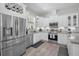 Modern kitchen featuring stainless steel appliances, white cabinetry, and granite countertops at 112 W Sligh Ave, Tampa, FL 33604