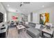 Bright living room with sleek gray sectional, modern art, and an open concept layout at 112 W Sligh Ave, Tampa, FL 33604