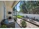 Screened-in patio with comfortable seating, a TV, and views of the fenced yard at 112 W Sligh Ave, Tampa, FL 33604