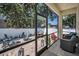 Enclosed patio with brick floors, outdoor seating, grill, and mature trees at 112 W Sligh Ave, Tampa, FL 33604