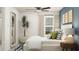Inviting bedroom with a cozy bed, decorative pillows, and a stylish mirror at 12442 Radiant Crystal Rose, Parrish, FL 34219
