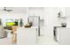 Modern kitchen with white cabinets, stainless steel appliances, and a convenient breakfast bar at 12442 Radiant Crystal Rose, Parrish, FL 34219