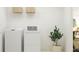 Clean laundry room featuring a modern washer and dryer, and practical storage solutions at 12442 Radiant Crystal Rose, Parrish, FL 34219