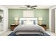 Serene bedroom featuring a plush bed, matching nightstands, a ceiling fan, and calming decor at 12442 Radiant Crystal Rose, Parrish, FL 34219