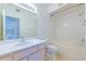 Bright bathroom featuring a single sink vanity and a shower-tub combination with tiled walls at 13025 Sanctuary Cove Dr # 301, Temple Terrace, FL 33637