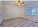 Well-lit bedroom featuring wood-look floors, a ceiling fan, and a window with blinds at 13025 Sanctuary Cove Dr # 301, Temple Terrace, FL 33637
