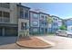 A view of the condo building featuring muted gray and blue tones and balconies. Unit number 301 is outlined in red at 13025 Sanctuary Cove Dr # 301, Temple Terrace, FL 33637