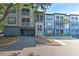 A view of the condo building featuring muted gray and blue tones, multiple stories, and balconies at 13025 Sanctuary Cove Dr # 301, Temple Terrace, FL 33637