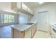 Kitchen overlooking living room with bright light from large windows at 13025 Sanctuary Cove Dr # 301, Temple Terrace, FL 33637