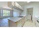Bright kitchen with bar seating, stainless steel sink and view into the living room and laundry room at 13025 Sanctuary Cove Dr # 301, Temple Terrace, FL 33637