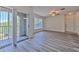 Open living area features new grey flooring, ceiling fan, and sliding glass doors to the balcony at 13025 Sanctuary Cove Dr # 301, Temple Terrace, FL 33637