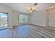 Open living area features new grey flooring, ceiling fan, and sliding glass doors to the balcony at 13025 Sanctuary Cove Dr # 301, Temple Terrace, FL 33637