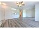 A spacious living room and dining area combo features modern gray floors and a ceiling fan at 13025 Sanctuary Cove Dr # 301, Temple Terrace, FL 33637