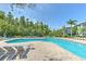 Community pool with lounge chairs and shade pergola at the Preserve at Palmaire at 13025 Sanctuary Cove Dr # 301, Temple Terrace, FL 33637