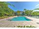 Inviting community pool with comfortable lounge chairs and meticulously designed brick pavers at 13025 Sanctuary Cove Dr # 301, Temple Terrace, FL 33637