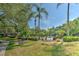 Community pool area with lush landscaping, BBQ grill and a well-maintained fence at 13025 Sanctuary Cove Dr # 301, Temple Terrace, FL 33637
