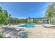 Community pool with lounge chairs and shade pergola at the Preserve at Palmaire at 13025 Sanctuary Cove Dr # 301, Temple Terrace, FL 33637