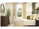 Cozy bedroom featuring stylish dresser, white metal bedframe, and soothing neutral tones at 13138 Empress Jewel Trl, Parrish, FL 34219
