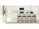 Modern kitchen boasts white cabinets, stainless steel appliances, and a large island with bar stool seating at 13138 Empress Jewel Trl, Parrish, FL 34219