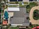 Stunning aerial view of the backyard featuring a private pool, spa, and lush landscaping at 132 Giralda Ne Blvd, St Petersburg, FL 33704