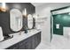 Modern bathroom features a double vanity with sleek countertop, gold fixtures, and oval mirrors at 132 Giralda Ne Blvd, St Petersburg, FL 33704