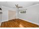 Well-lit bedroom with beautiful hardwood floors, a ceiling fan, and a double-door closet at 132 Giralda Ne Blvd, St Petersburg, FL 33704