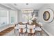 Dining area featuring a modern chandelier, luxury furnishings, and natural light from the window at 132 Giralda Ne Blvd, St Petersburg, FL 33704
